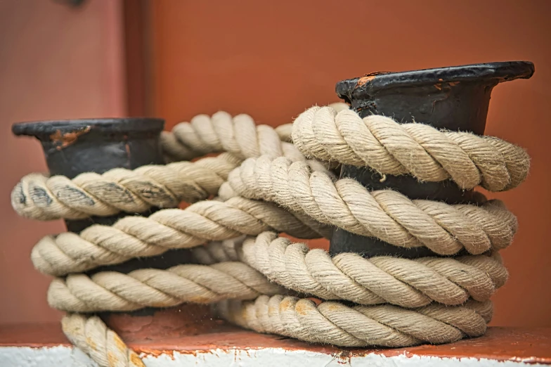 rope with black finings and brown edges on old wooden base