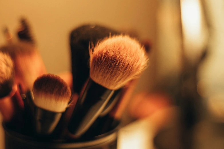 brushes in a container on a counter in a room