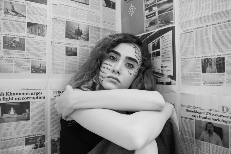 a woman has her arm wrapped up as she sits with her face painted