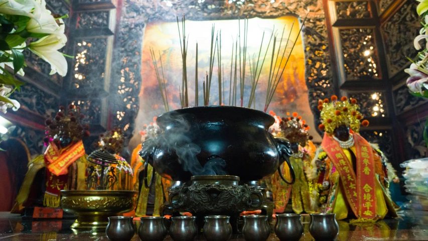 some incense is being displayed at an altar