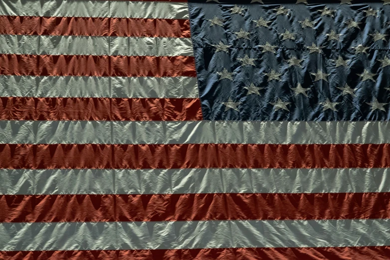 an old american flag sitting outside a window