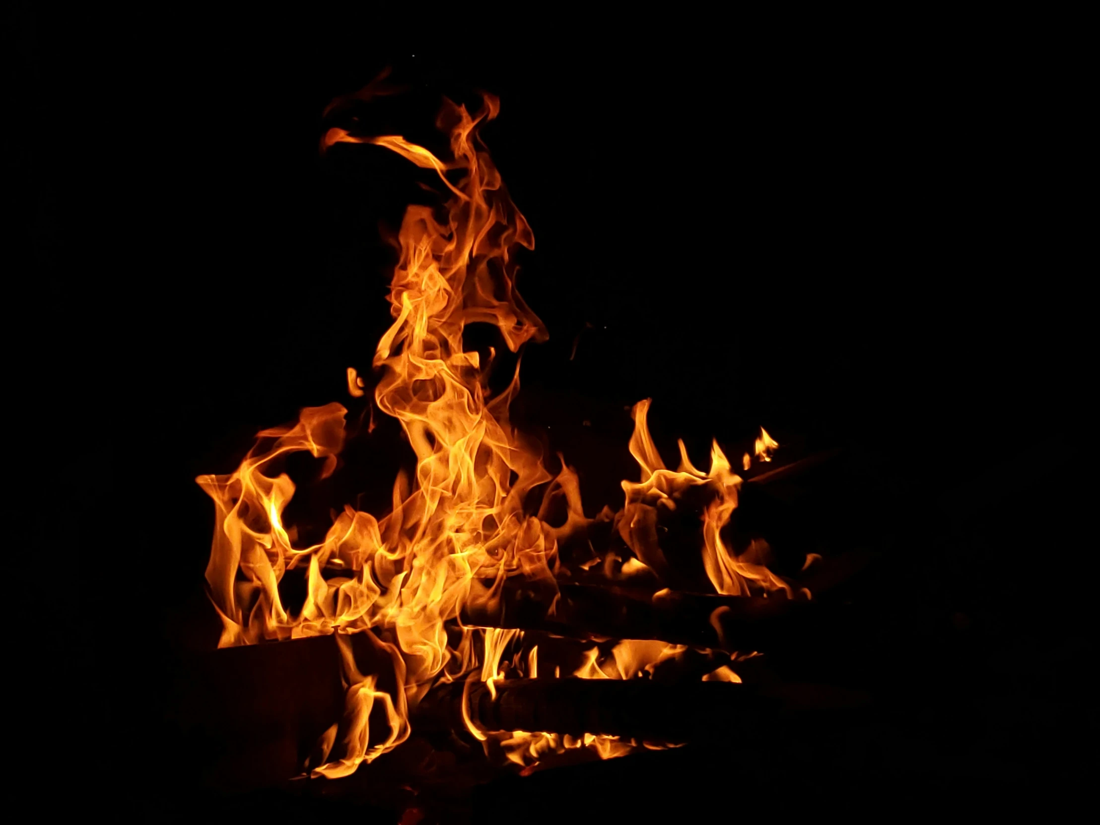 fire blazing in the night with flames coming from it