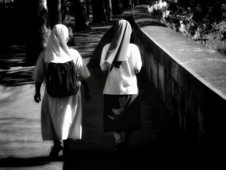 a black and white po of two people walking together