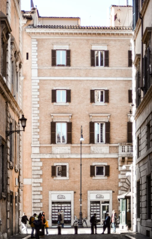 people walking on a street lined with buildings