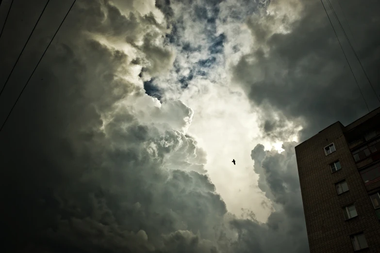 a very tall building under a cloudy sky