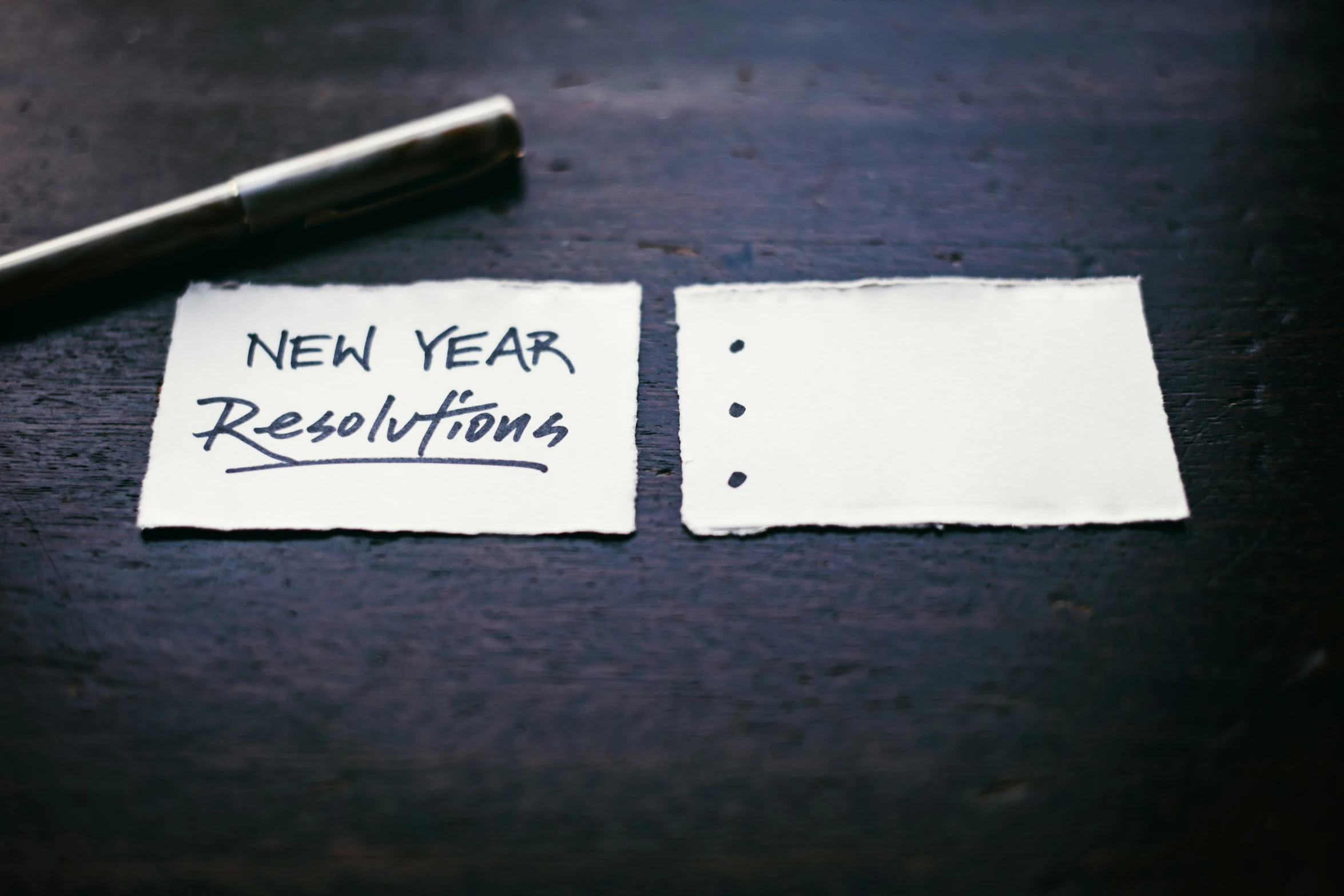 two pieces of paper with the words new year resolutions written on them