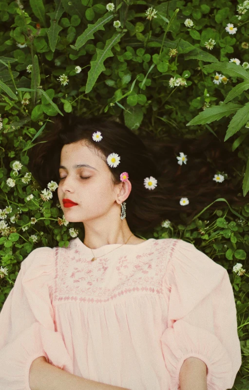 a woman with a pink dress and daisies in her hair