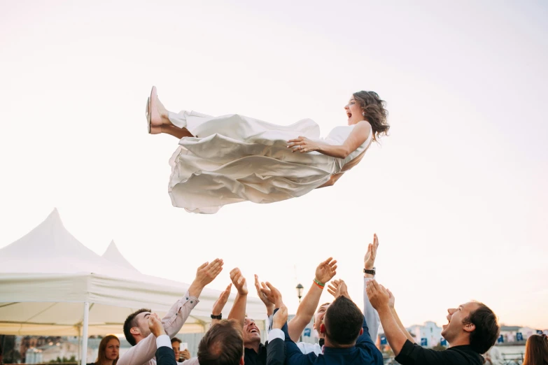 a man holds up a woman and other people