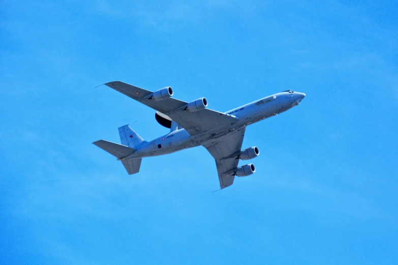 an airplane in the sky flying overhead