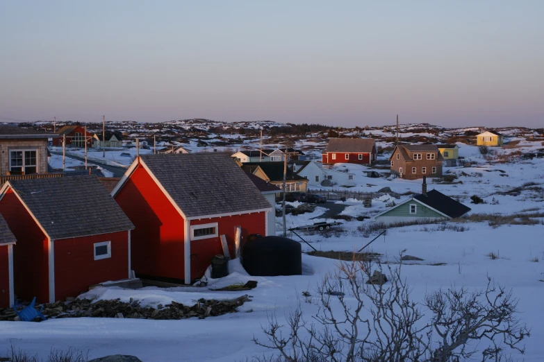 the red buildings are by each other in the snow