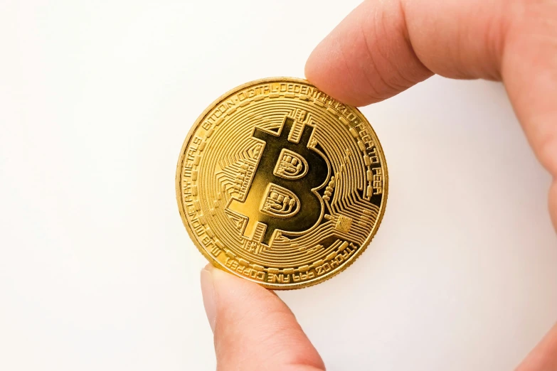 a close - up of a hand holding a bitcoin