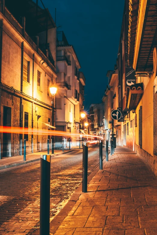 street lights are lit up on a city sidewalk