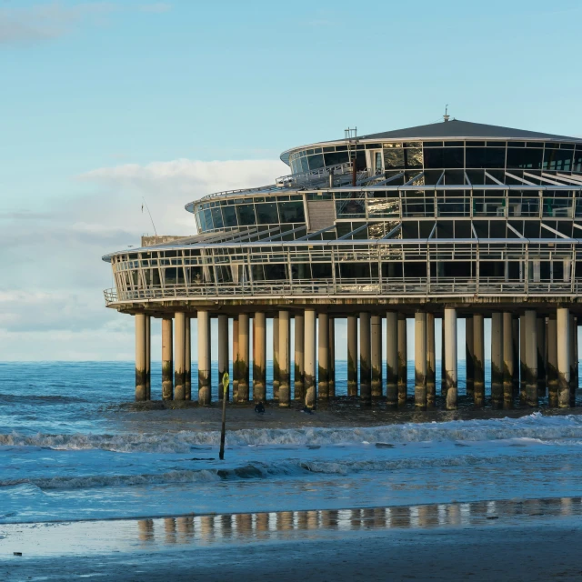 a large structure on the beach that is partially submerged in some water