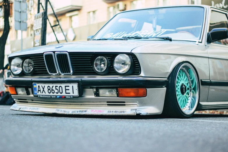 an old bmw with a green wheel and rim on it's grille