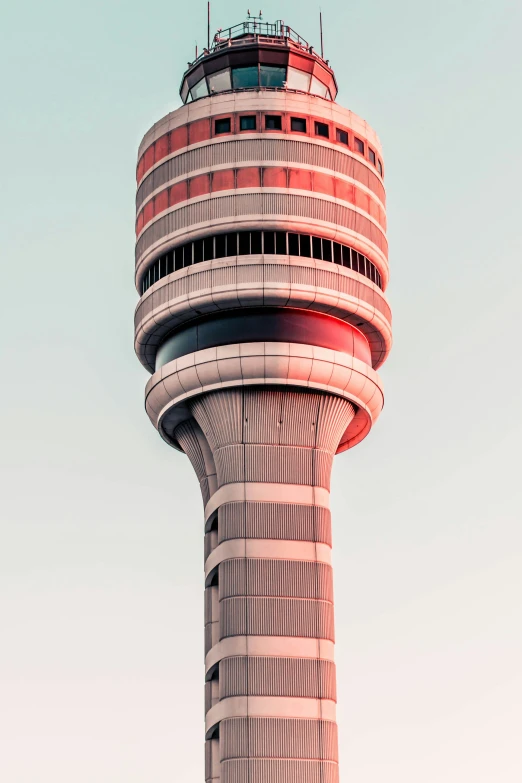 a plane flying by the top of a control tower