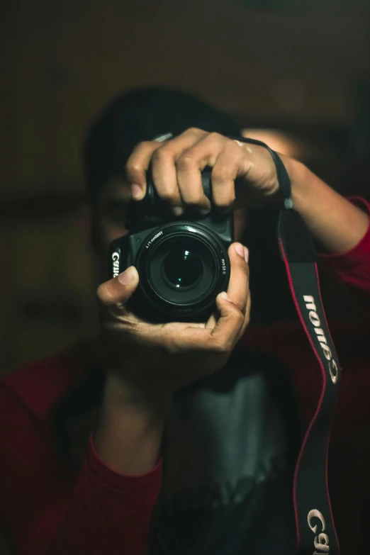 man holding up camera in front of his face