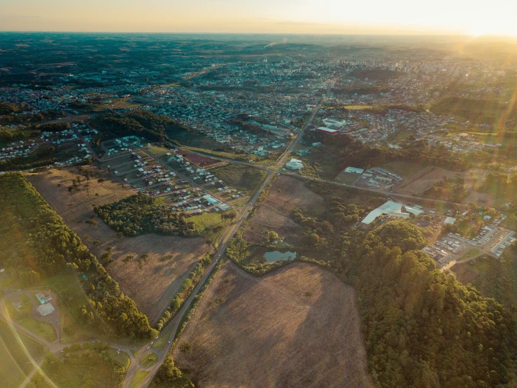 an aerial view of a lush green countryside with a small town in the distance