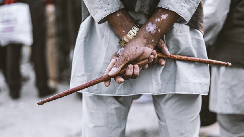 an older person holding a walking stick