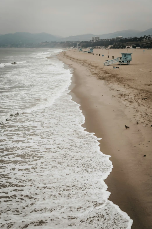 a sandy beach filled with lots of water