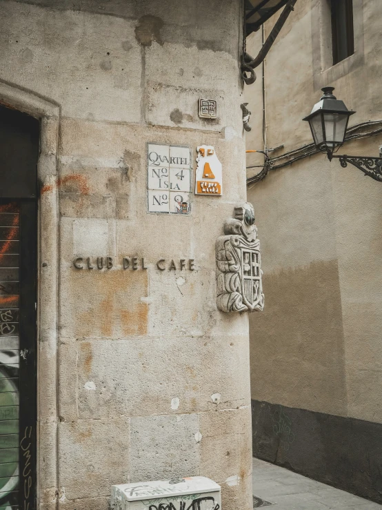 a building with a wall with signs on it and a owl statue