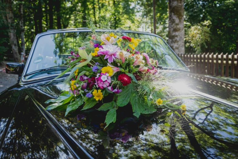 the bouquet of flowers is set on top of the car
