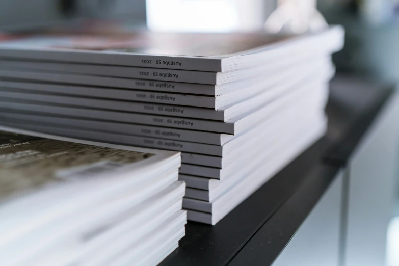 the stack of books is kept on a shelf