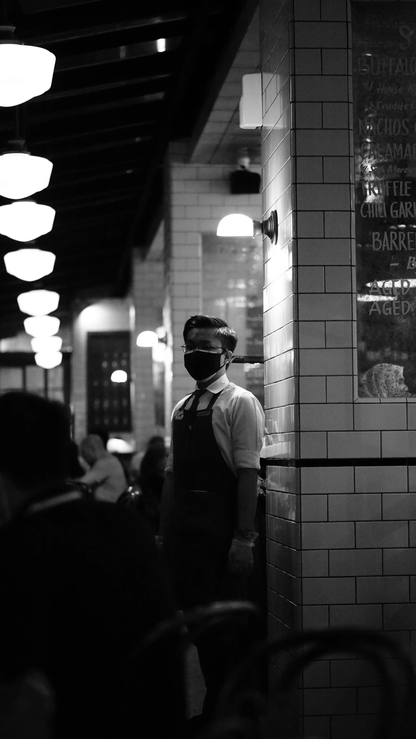 black and white pograph of a man at restaurant