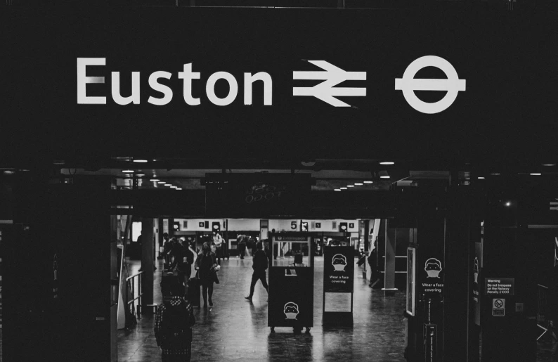 a black and white image of the entrance to a london subway station