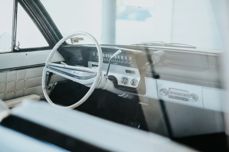 a vehicle dashboard with steering wheel and a manual and radio