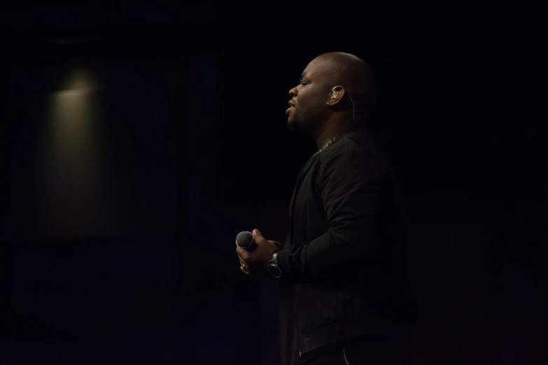 a man is giving a talk on stage