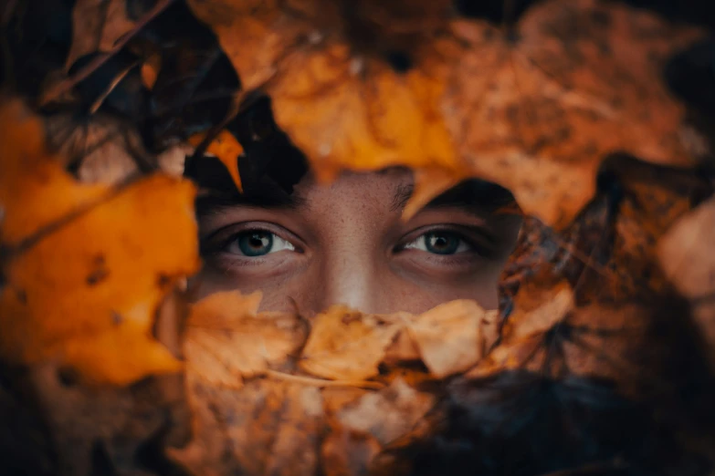 a close up image of a persons face with a tree nch