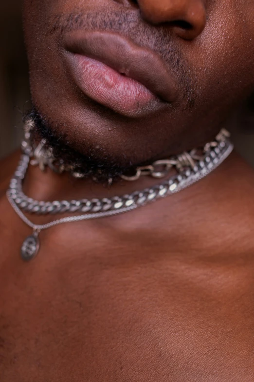 man with a neck chain around his neck