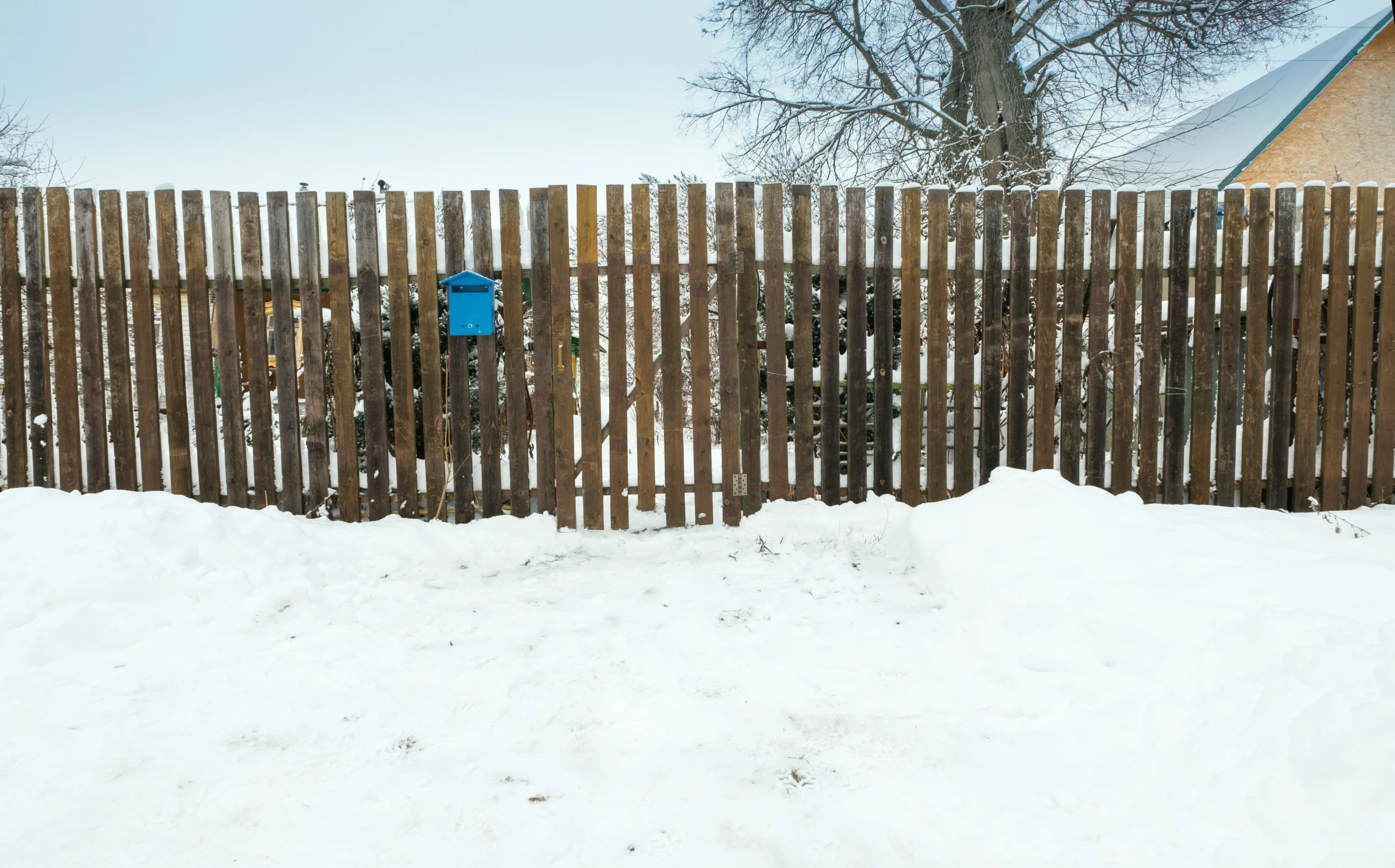 a snowboard is propped up against the fence