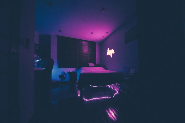 the bedroom glows purple and blue in contrast