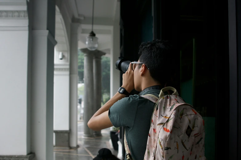 a man looking through binoculars at soing outside of him