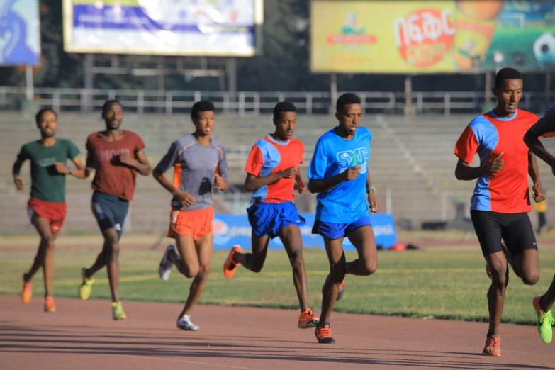 a group of young men running on a street