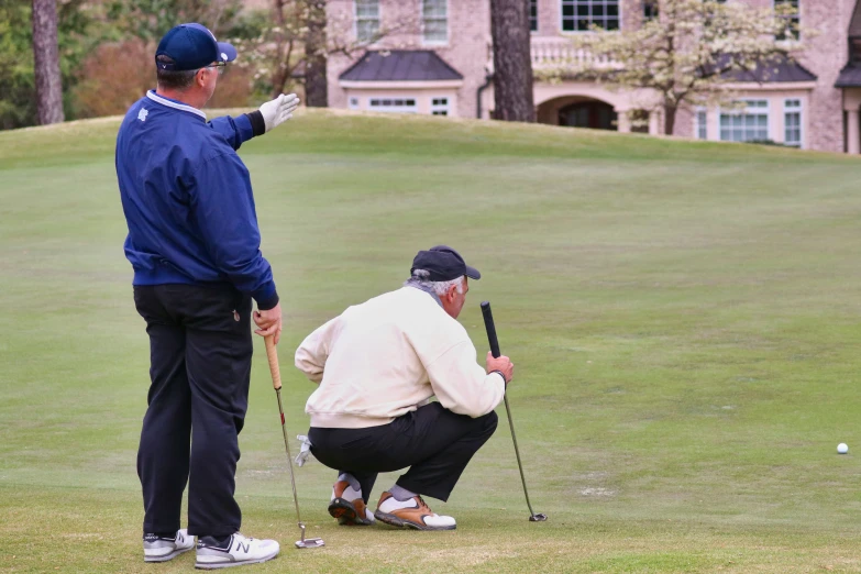 two golfers playing a game of golf on the golf course