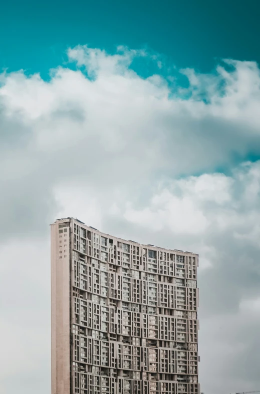 the sky above the large building has many windows