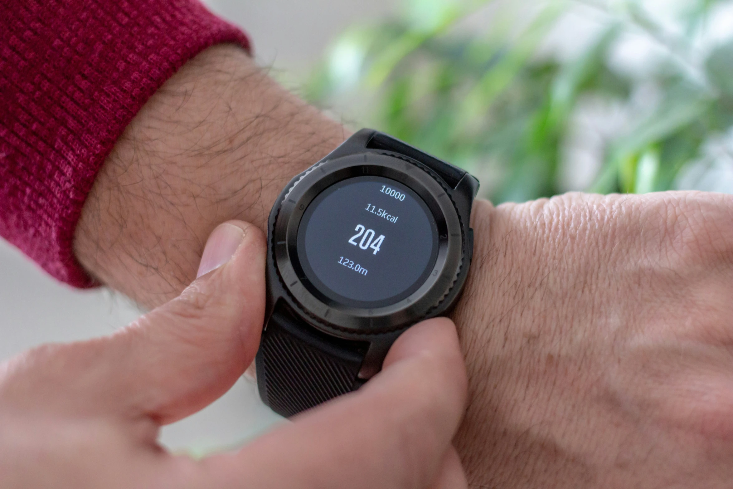 a person touching the smart watch on their wrist