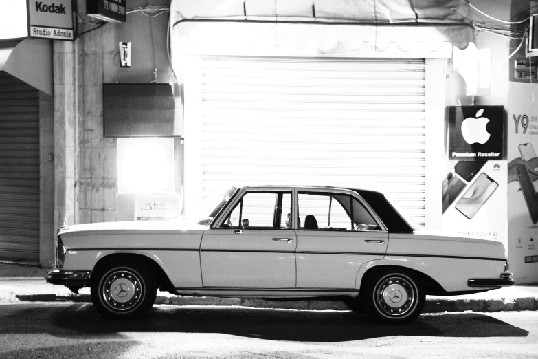 old bmw car sits parked in the street