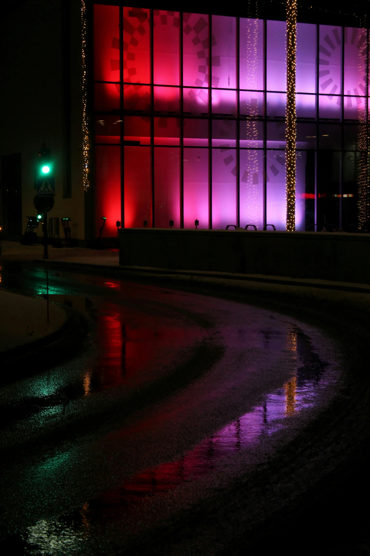 colorfully lit building next to a dark dle