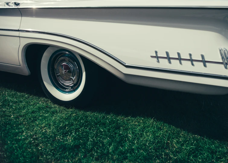 a close up of a car's emblem with grass in the background