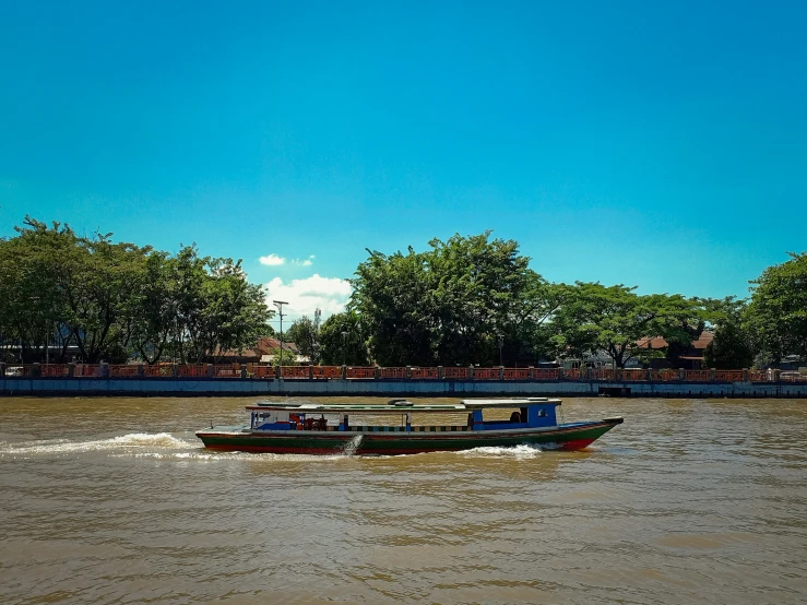 a small boat with four passengers in the water