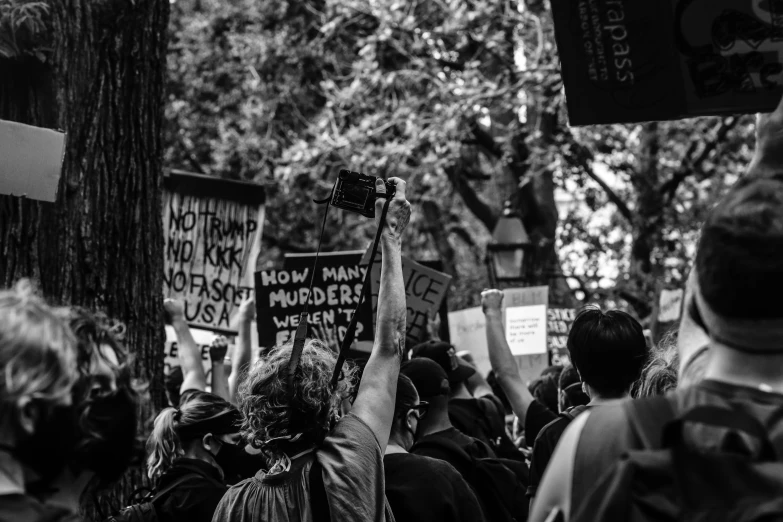 some people are holding up signs and making an obscene gesture