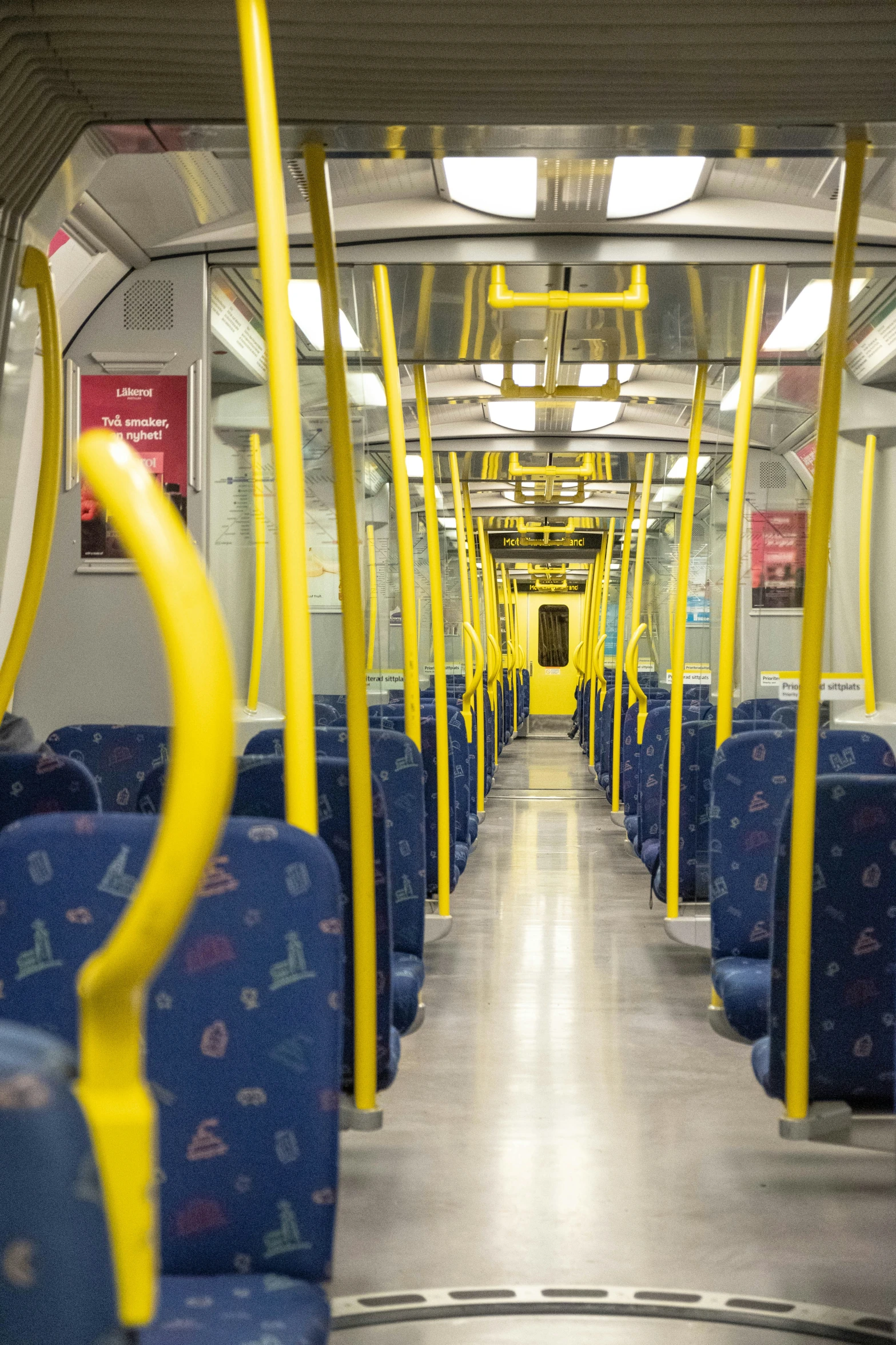 an empty bus with yellow and blue seats