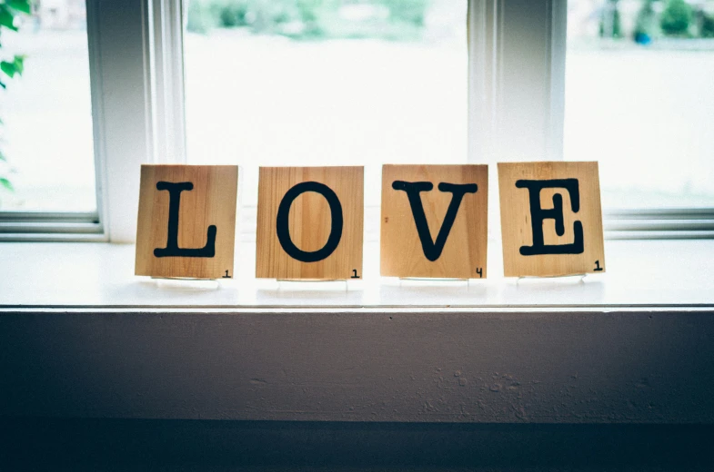 three small wooden letters with the word love written on them