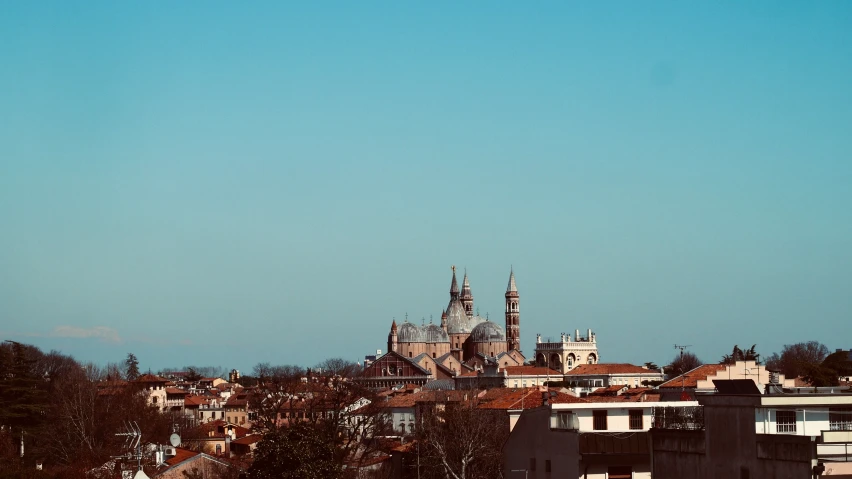 some buildings with a sky background that looks like an old castle