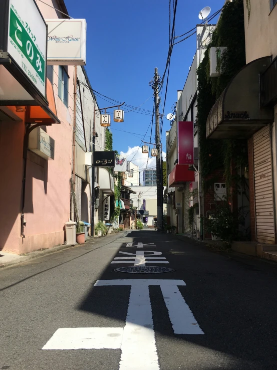 an empty street with buildings and signs