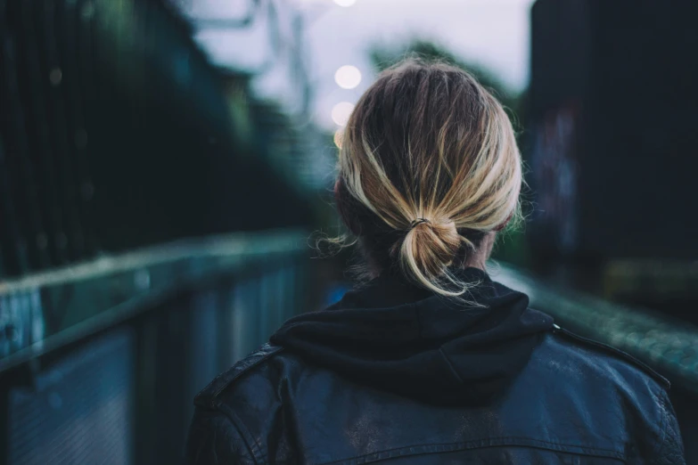 back view of woman's head in the distance and her hair pulled into a high pony tail