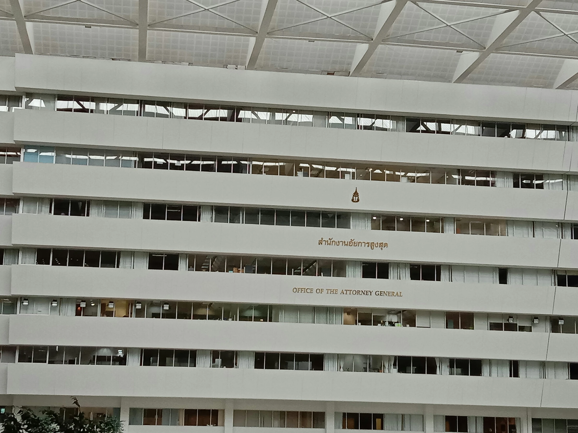 a tall building with several windows sitting under a roof